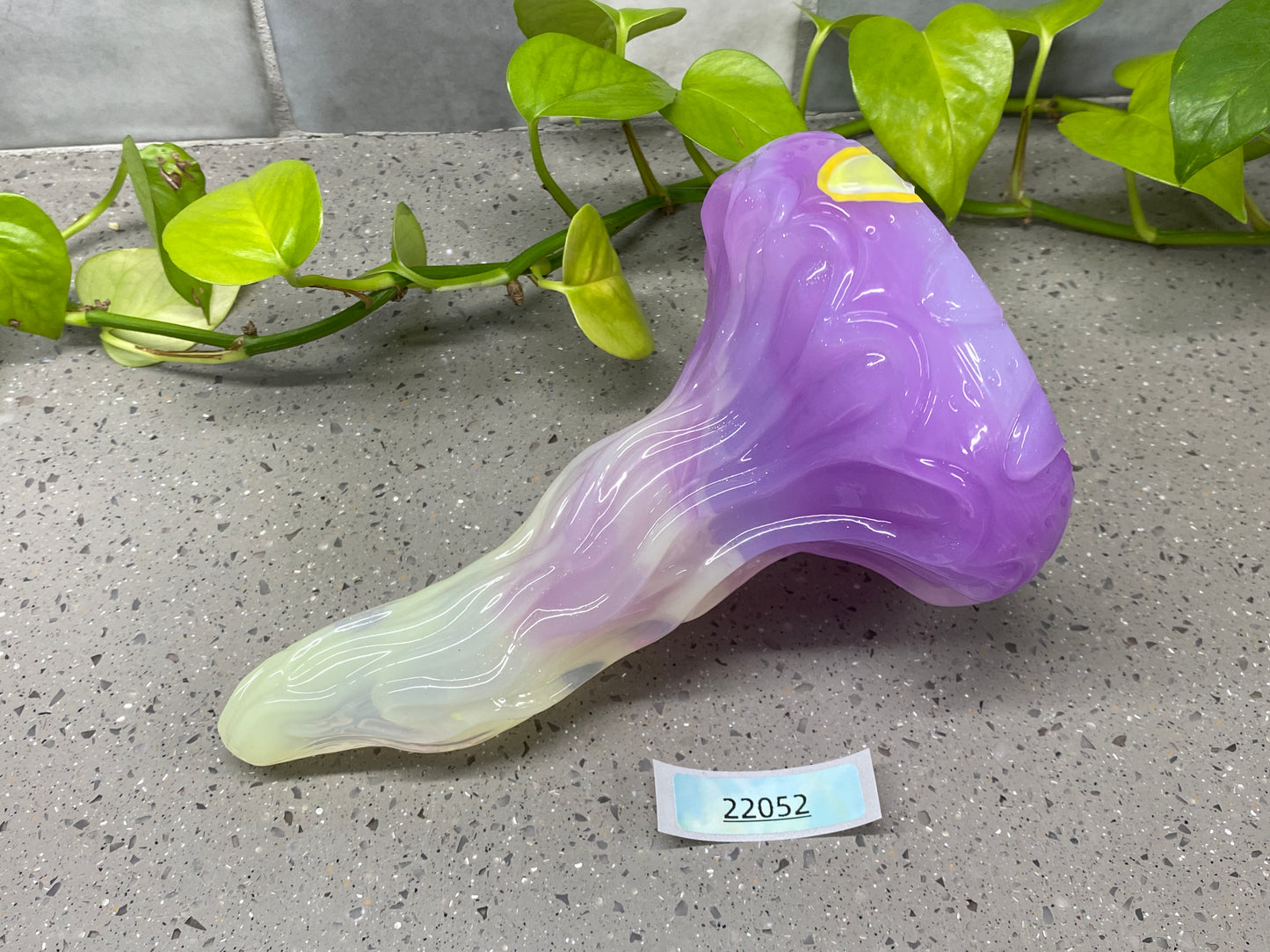 a purple and white vase sitting on top of a table