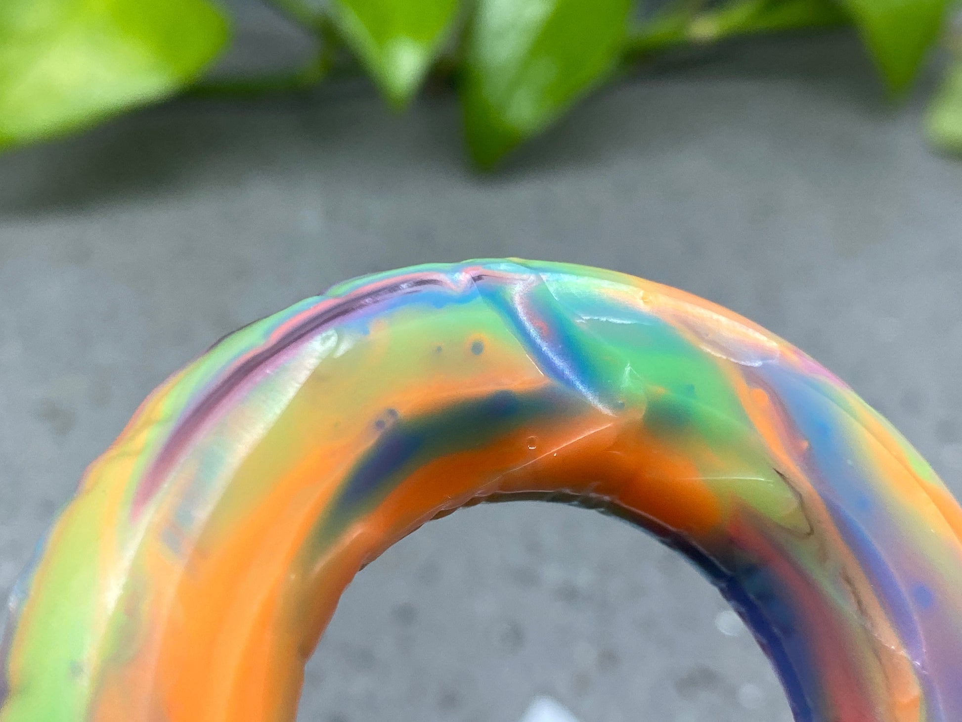 a close up of a colorful object near a plant