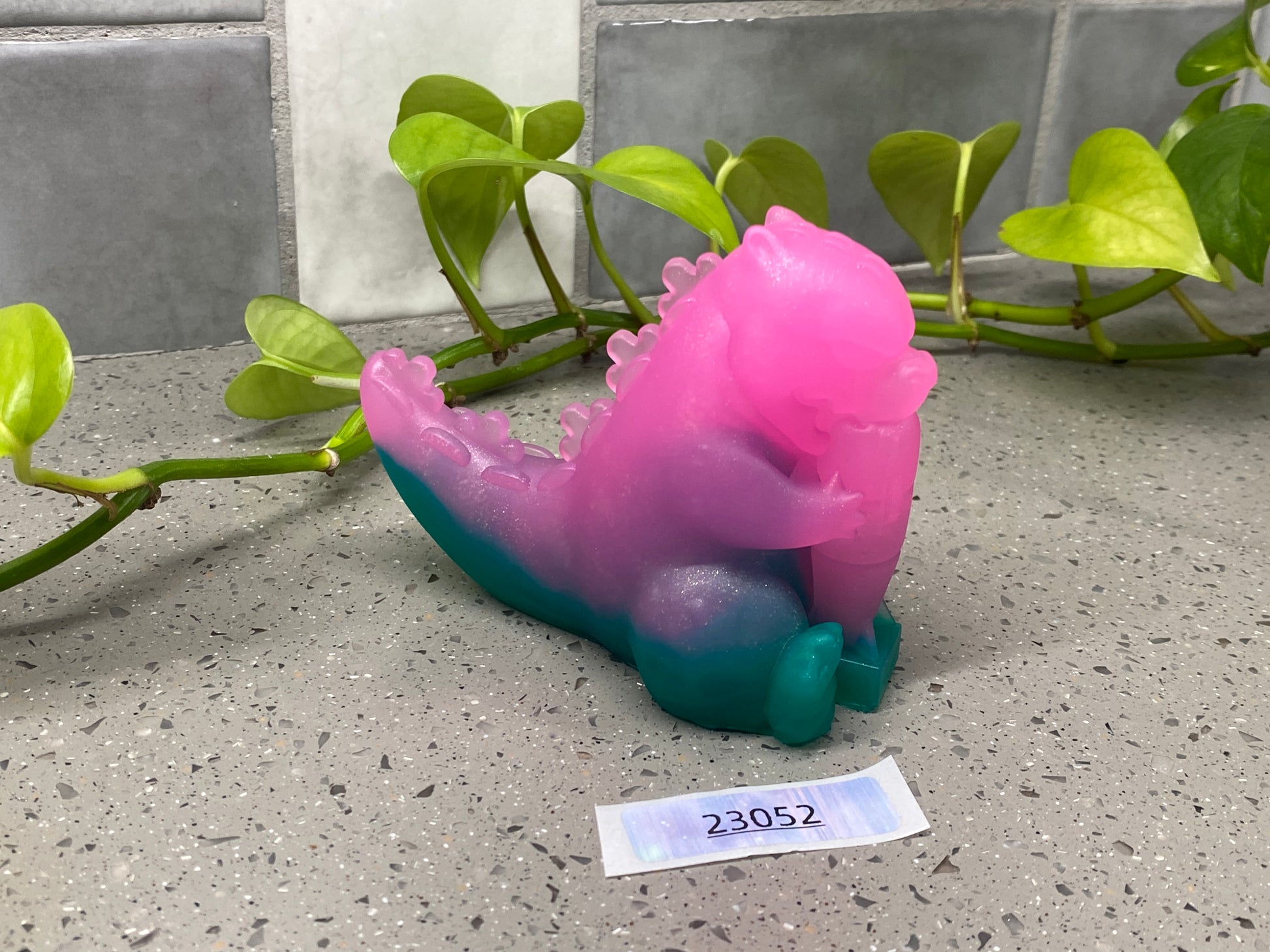 a pink and blue sea horse sitting on a counter