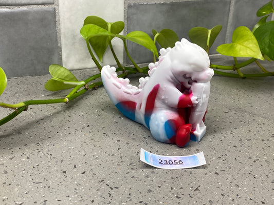 a small ceramic figurine sitting on a table next to a plant