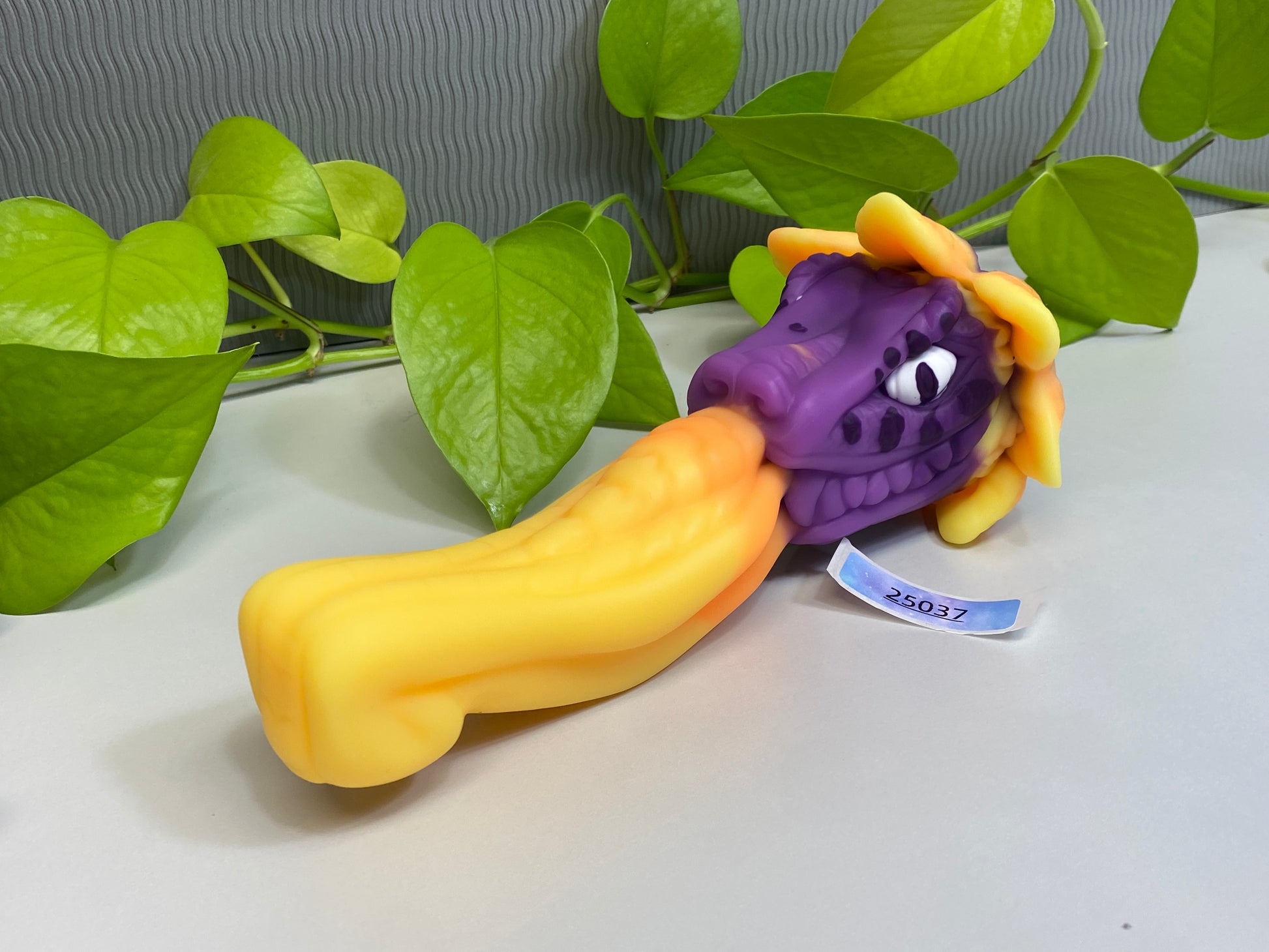 a purple toy laying on top of a white table