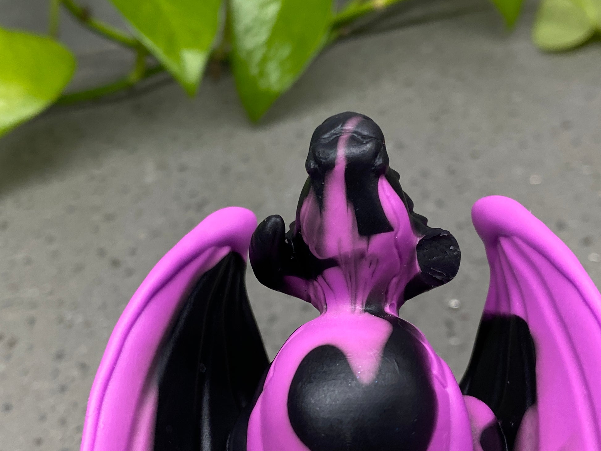 a close up of a purple and black dragon figurine
