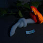 a stuffed animal laying on top of a table next to a plant