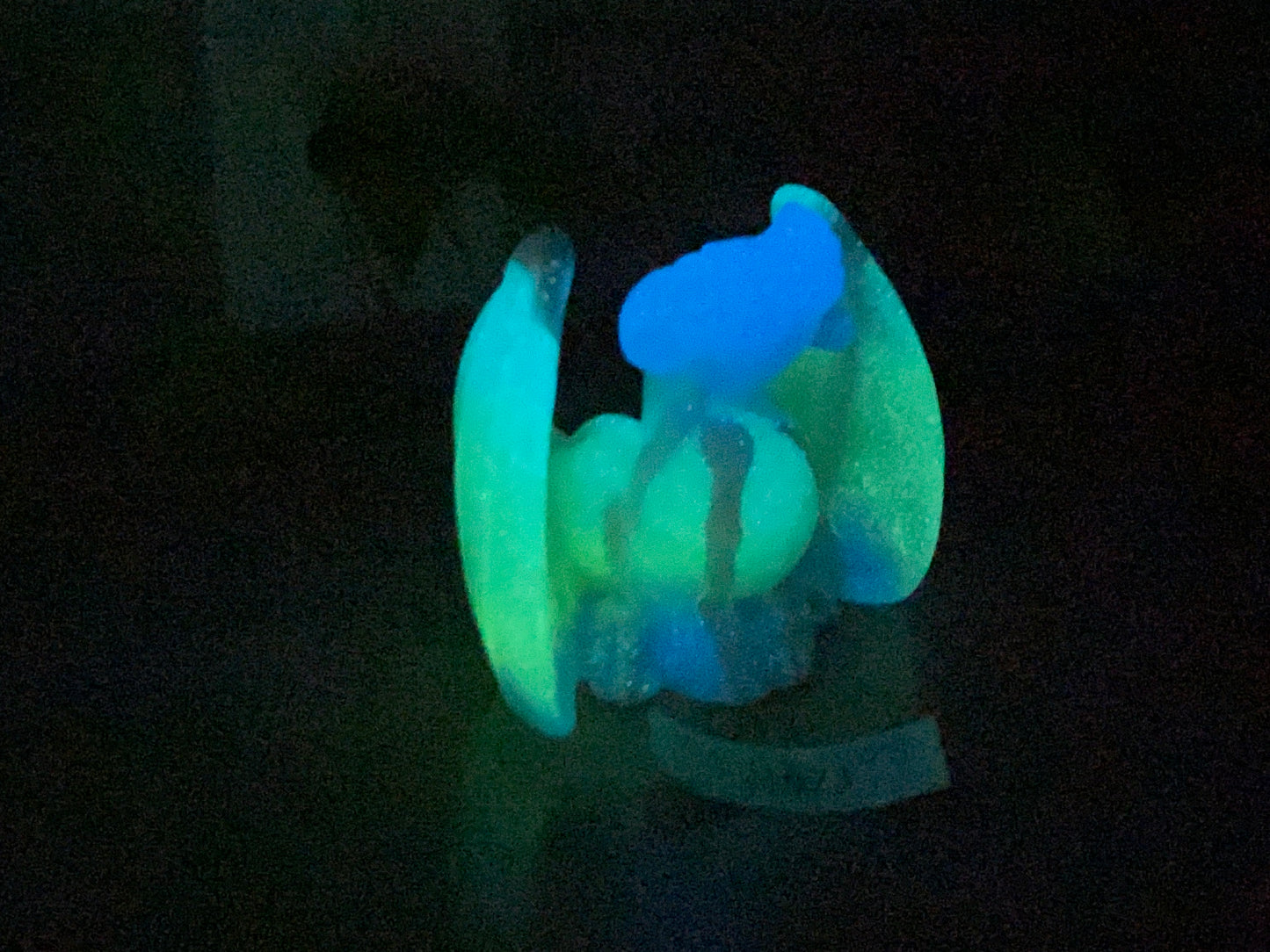 a glow in the dark toy sitting on a table