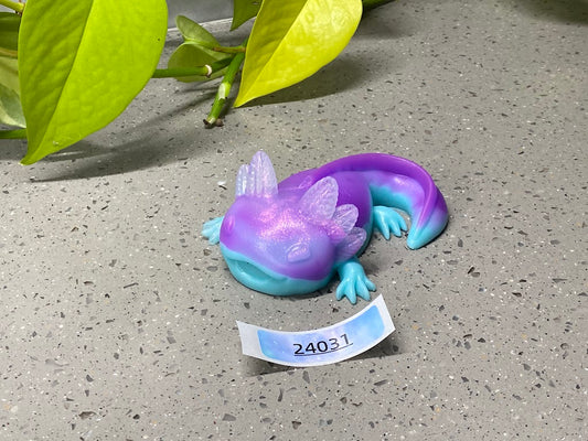 a purple and blue toy laying on top of a cement ground