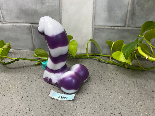 a purple and white vase sitting on top of a table