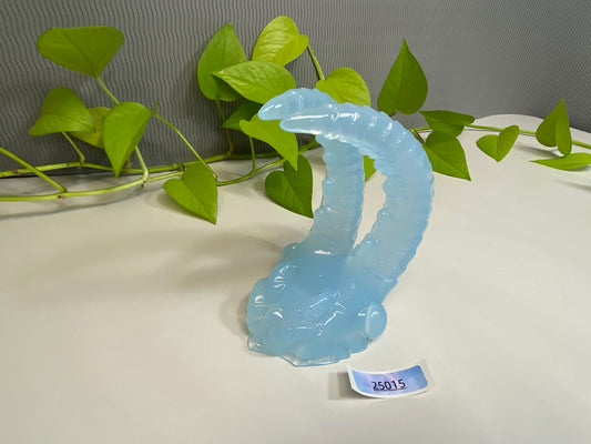 a glass sculpture of a worm on a table