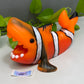 an orange and white clown fish figurine sitting on a table