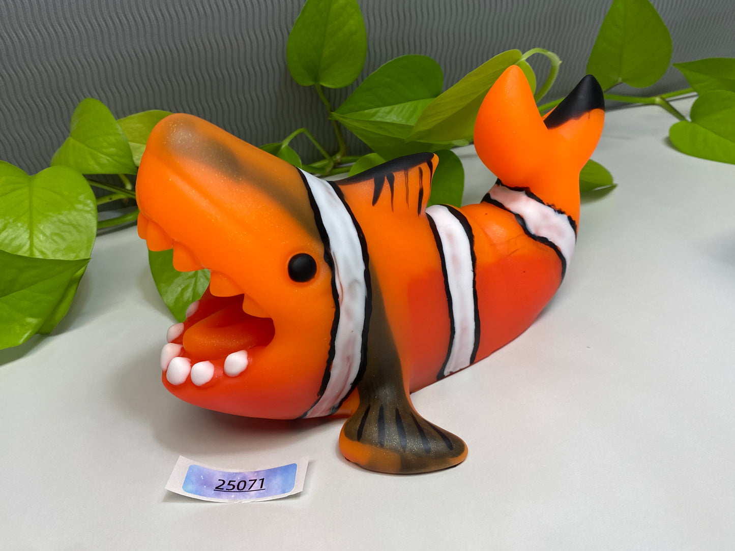 an orange and white clown fish figurine sitting on a table