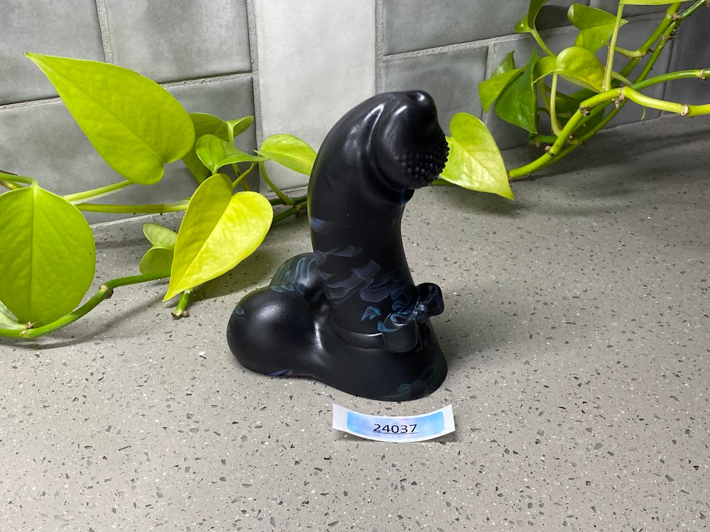 a black bear figurine sitting on top of a table