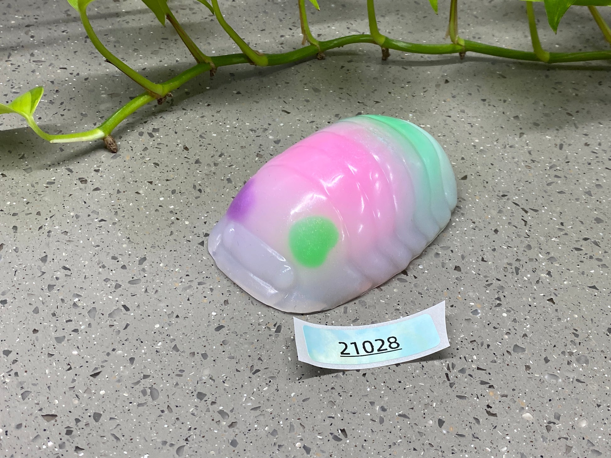 a colorful object sitting on top of a table next to a plant