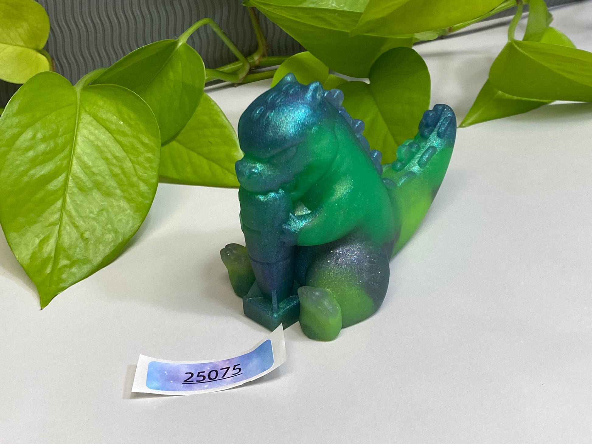 a green toy sitting on top of a white table