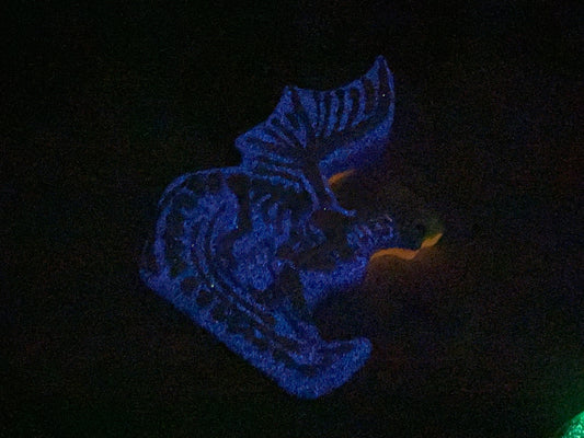 a lit up object in the dark with a black background