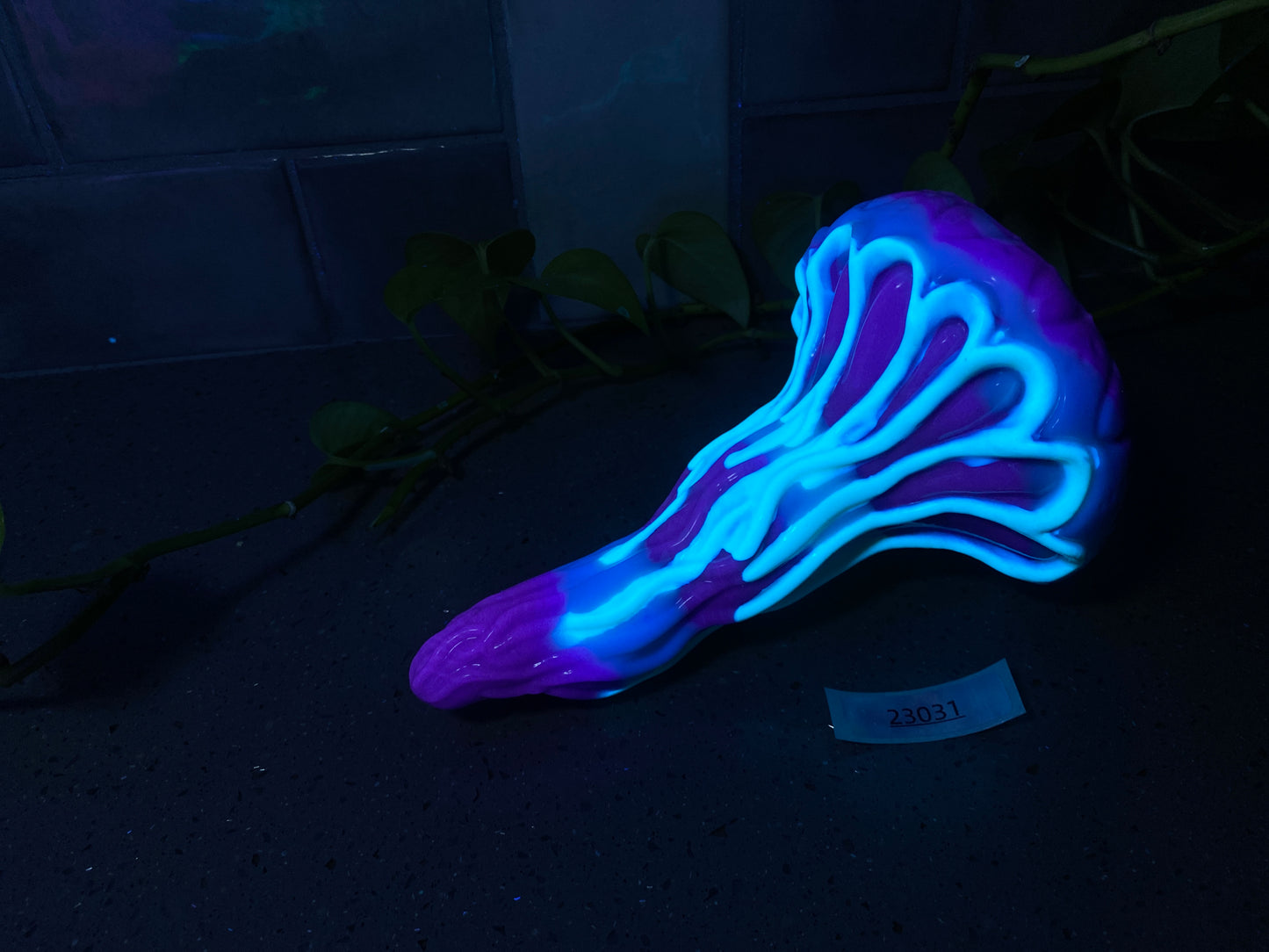 a blue and purple shoe sitting on top of a black floor