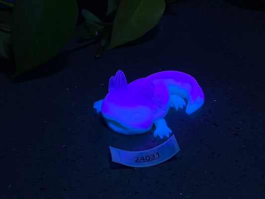 a toy lizard on a table with a name tag