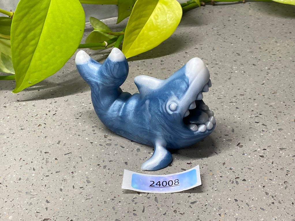 a blue ceramic dolphin figurine with its mouth open