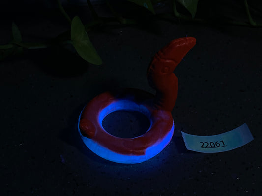 a red and blue ring sitting on top of a table