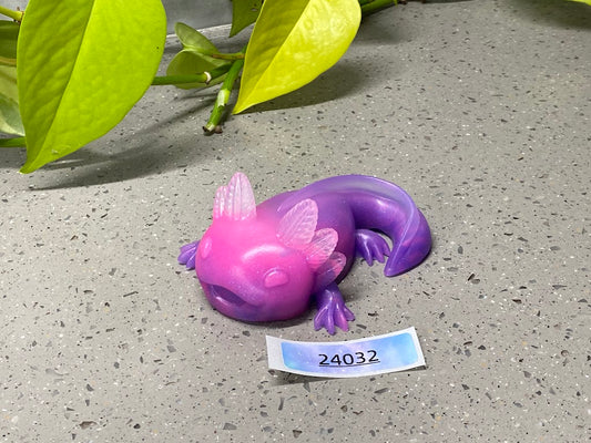 a purple and purple toy laying on top of a cement ground