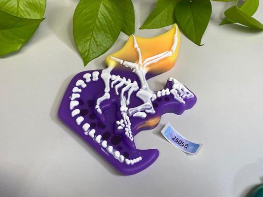 a purple toothbrush holder with a skeleton on it