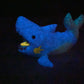 a blue stuffed animal that is glowing in the dark