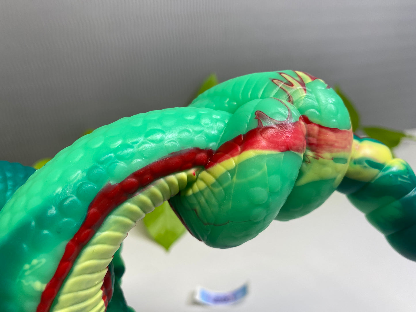 a close up of a toy snake on a table