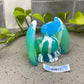 a glass figurine of a cat with a name tag