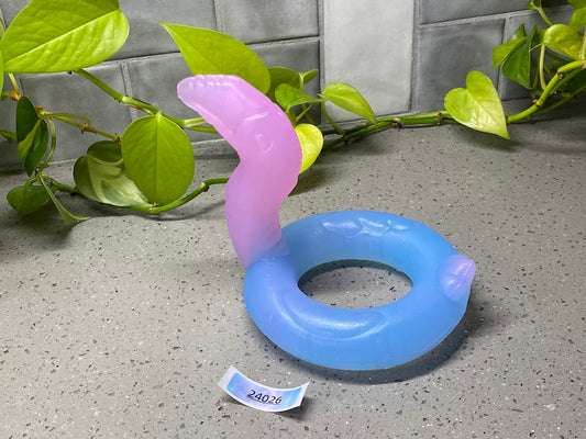 a blue and pink ring sitting on top of a table