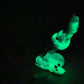 a glow in the dark teddy bear sitting on the ground