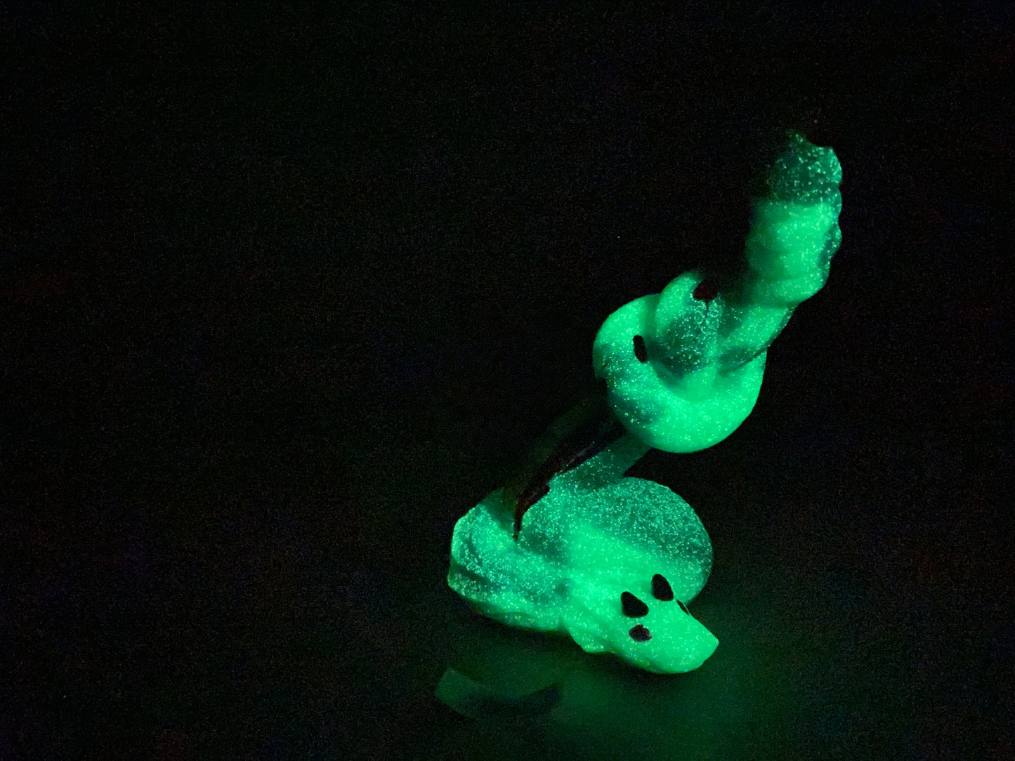 a glow in the dark teddy bear sitting on the ground