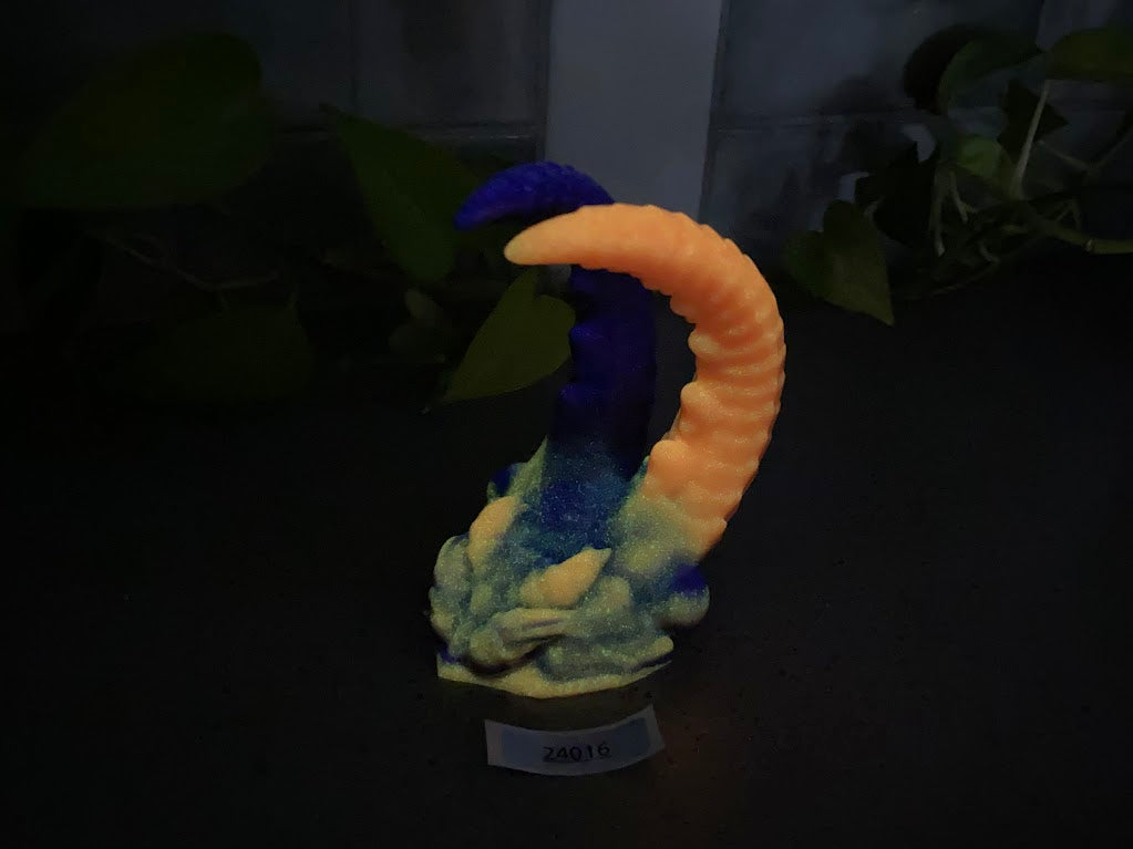 a blue and orange sculpture sitting on top of a table