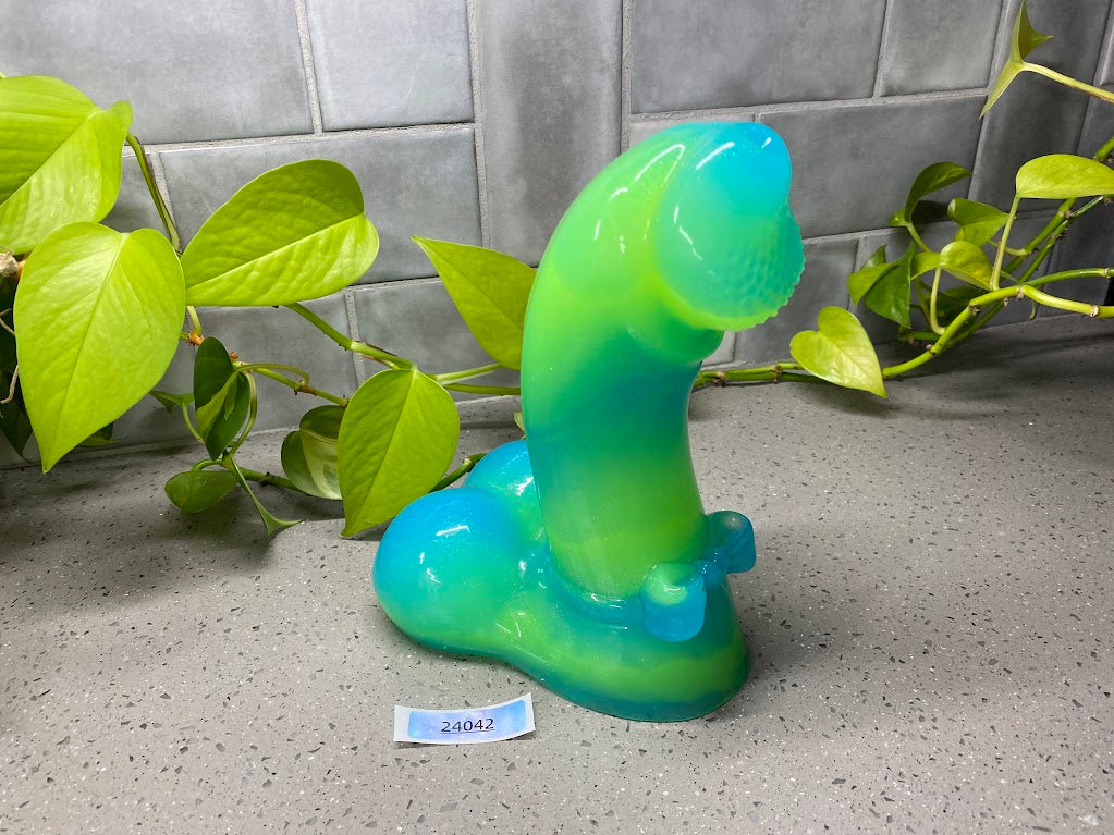 a green and blue sculpture sitting on top of a counter