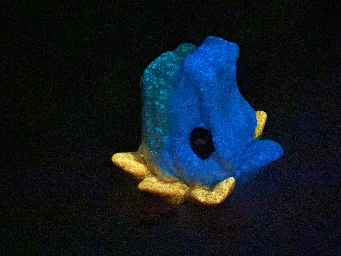 a blue and yellow toy sitting on top of a table