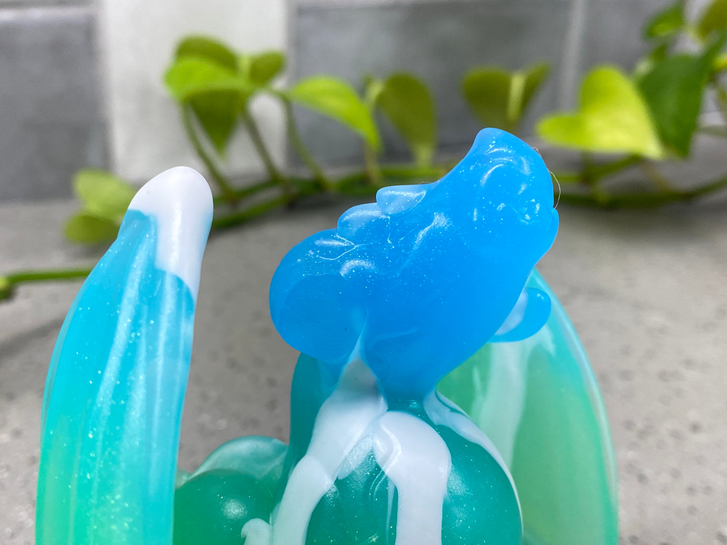 a close up of a blue and green toothbrush holder