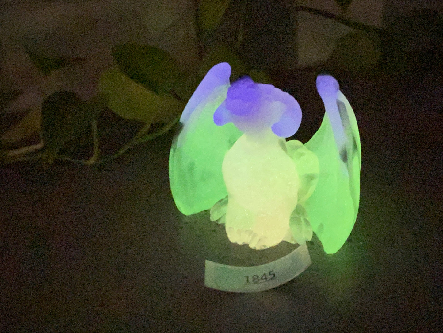 a green and blue light up object on a table