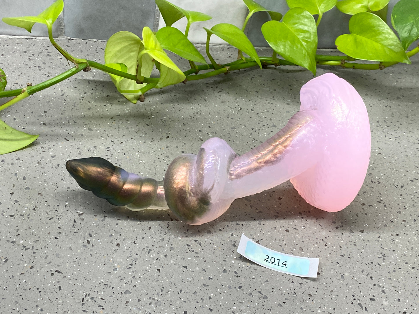 a pink glass pipe with a metal fitting on top of it