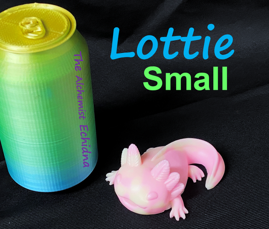 a small toy lizard next to a can of soda