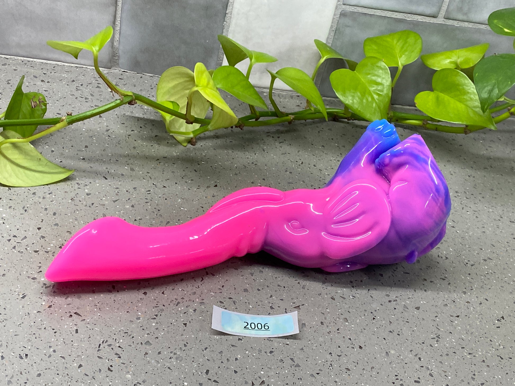 a pink and purple toy laying on top of a table