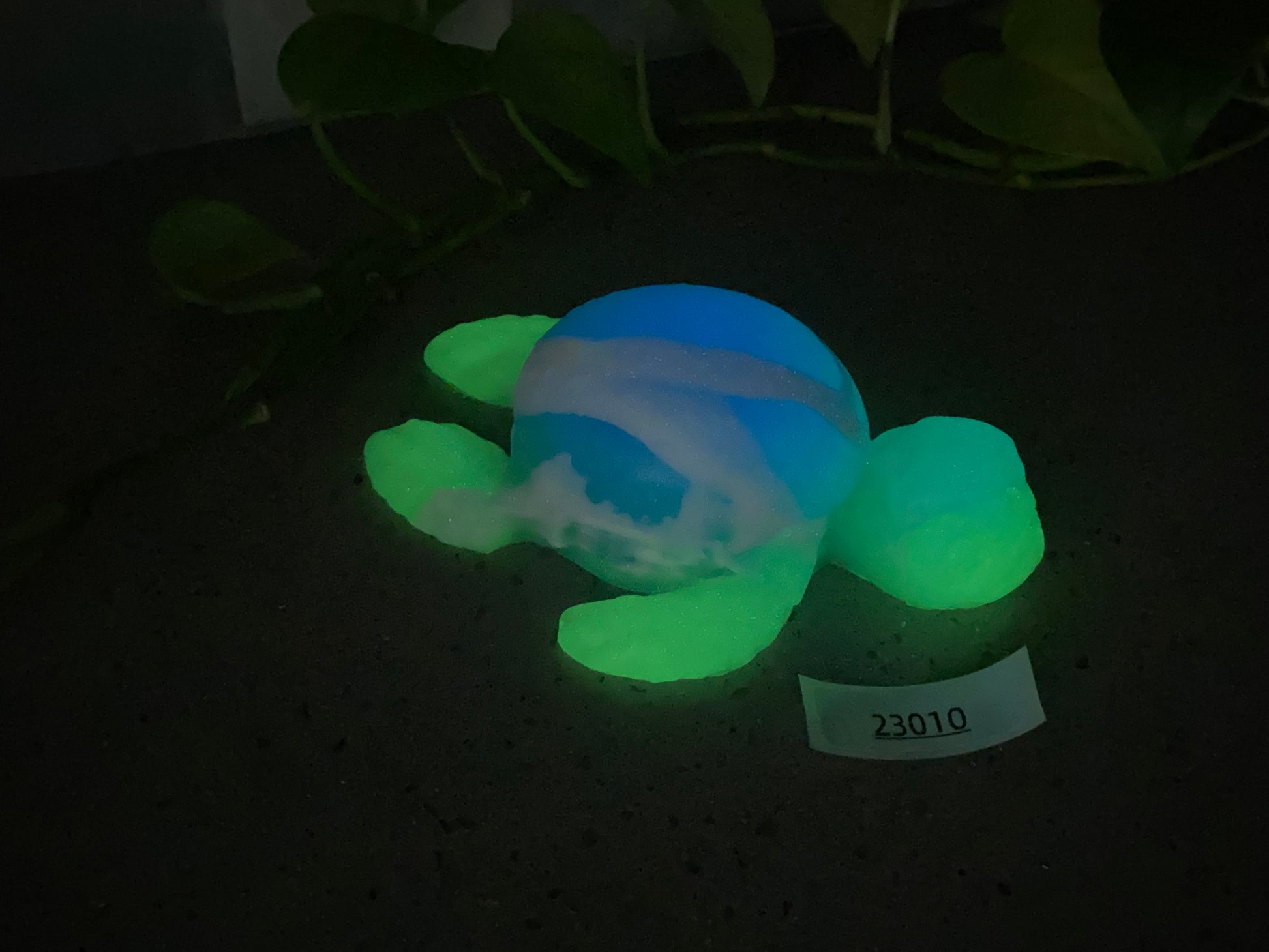 a glow in the dark turtle toy laying on the ground