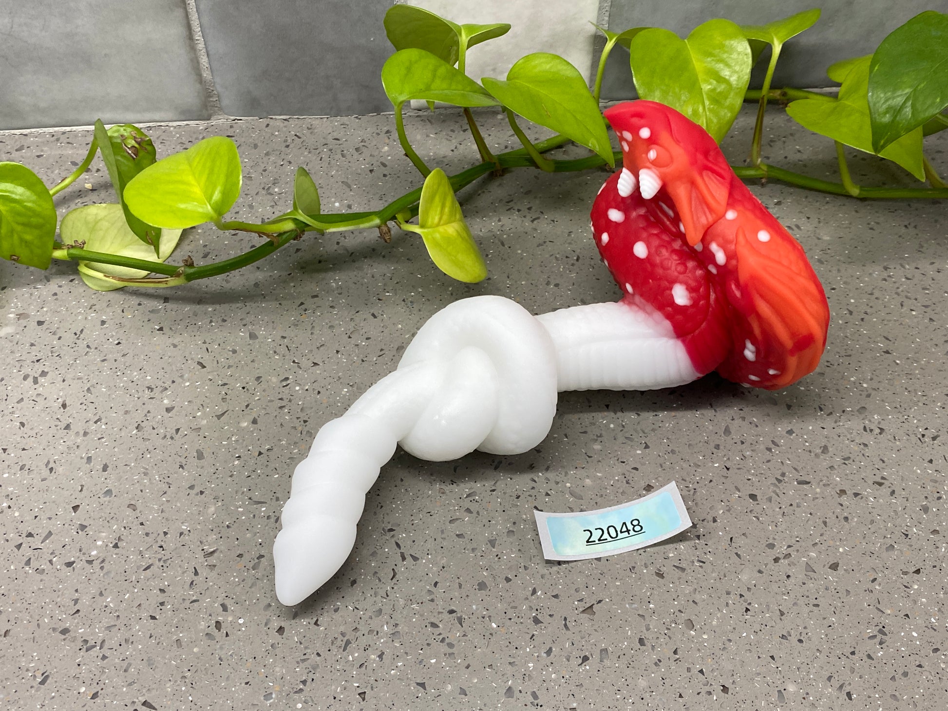 a red and white mushroom sitting on top of a table