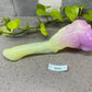 a purple and green object sitting on top of a counter