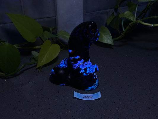 a statue of a black cat with blue lights