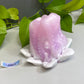 a pink flower sitting on top of a white table