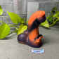 a rubber toy sitting on top of a table next to a plant