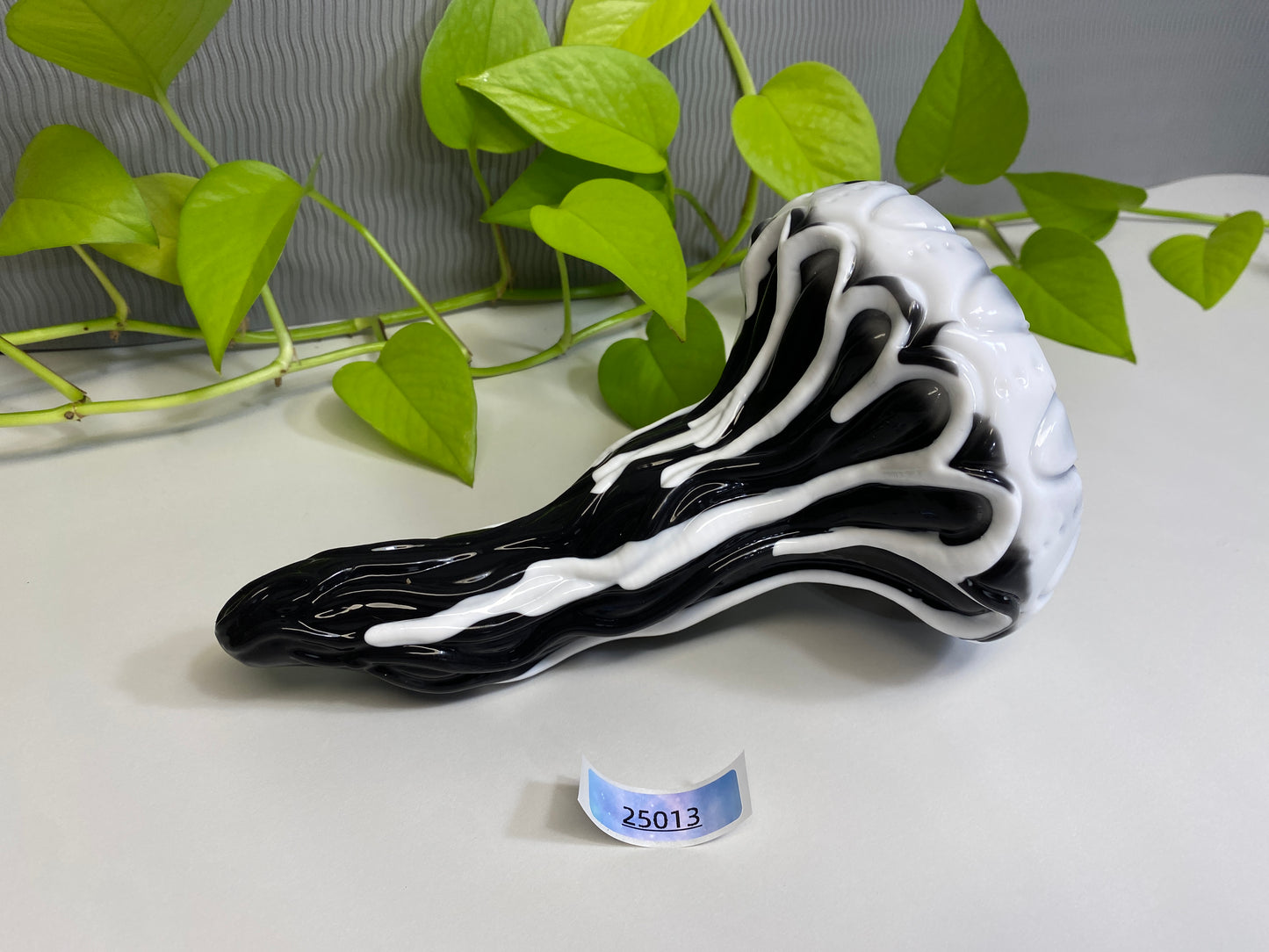 a black and white vase sitting on top of a table