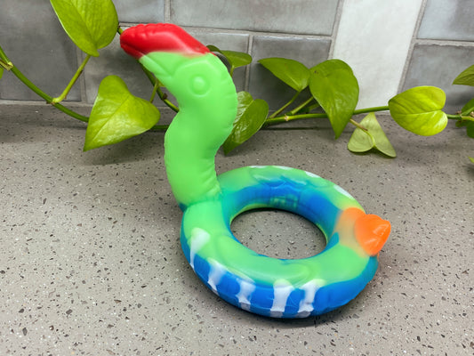 an inflatable toy sitting on a counter next to a plant
