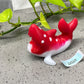 a red and white fish figurine sitting on top of a table