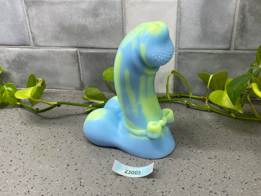 a blue and green statue sitting on top of a counter