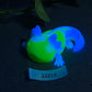 a glowing toy lizard sitting on top of a table