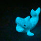 a blue stuffed animal is glowing in the dark