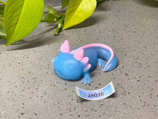 a blue toy with a pink horn laying on the ground